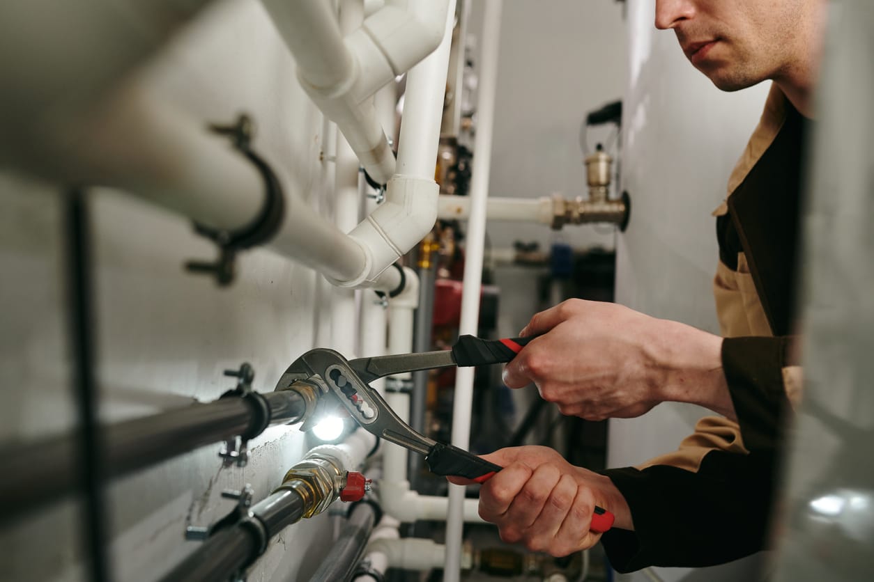 Plumbers maintaining commercial plumbing pipes in Bartow