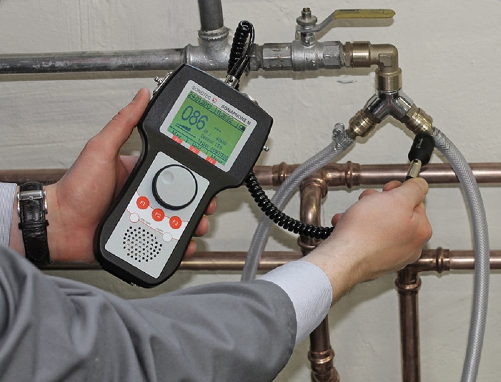 Plumber testing pipes with electronic leak detection equipment in Bartow