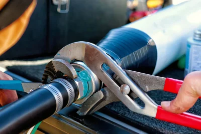 Technician tightening an industrial pipe connection in Bartow