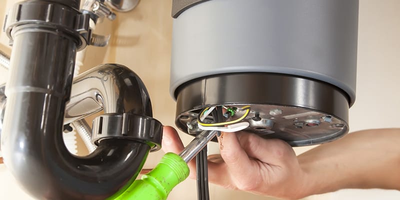 Technician repairing the heating element of a water heater in Bartow