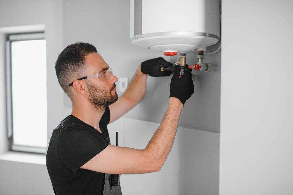 Technician performing water heater maintenance in Bartow