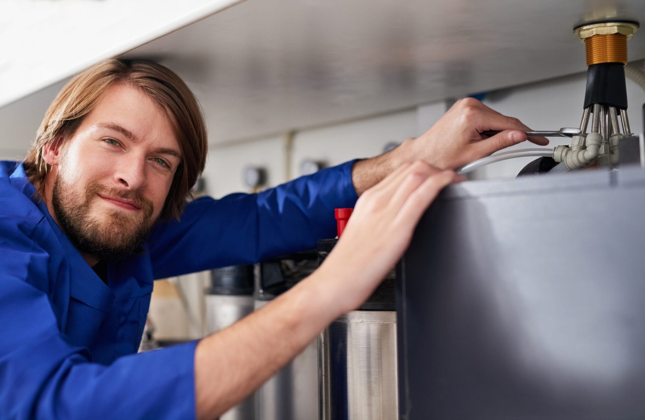 Technician servicing a residential water heater tank in Bartow