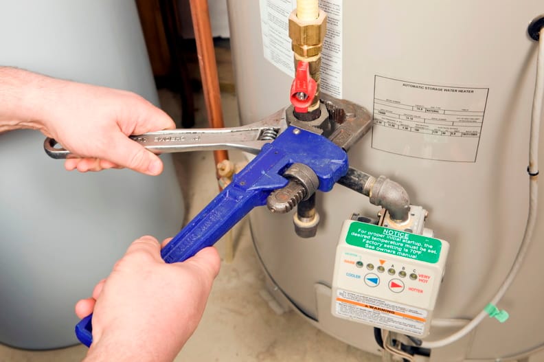 Plumber repairing a water heater valve in Bartow